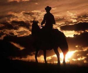 yapboz Cowboy günbatımında sürme